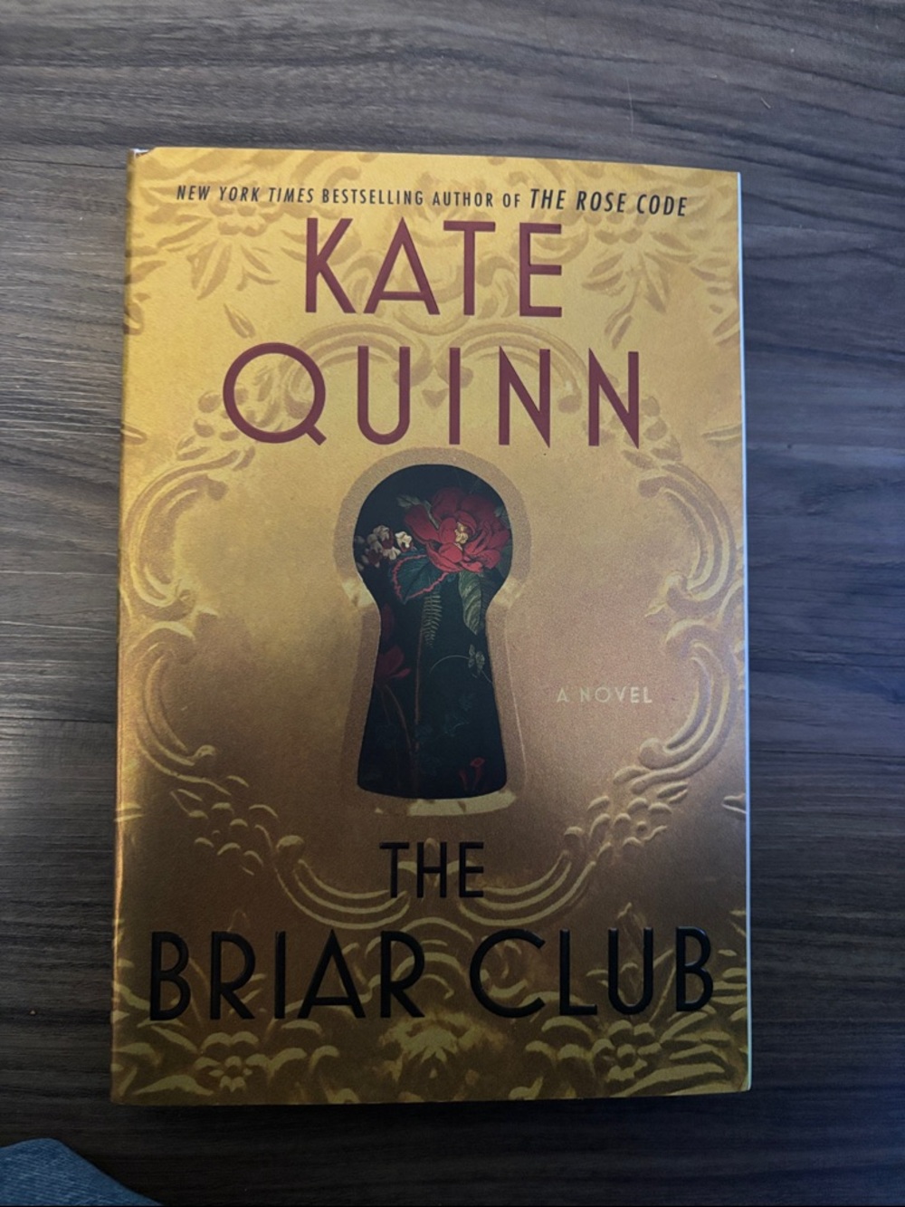 Kate Quinn Gold paperback with Red and Black Keyhole Design